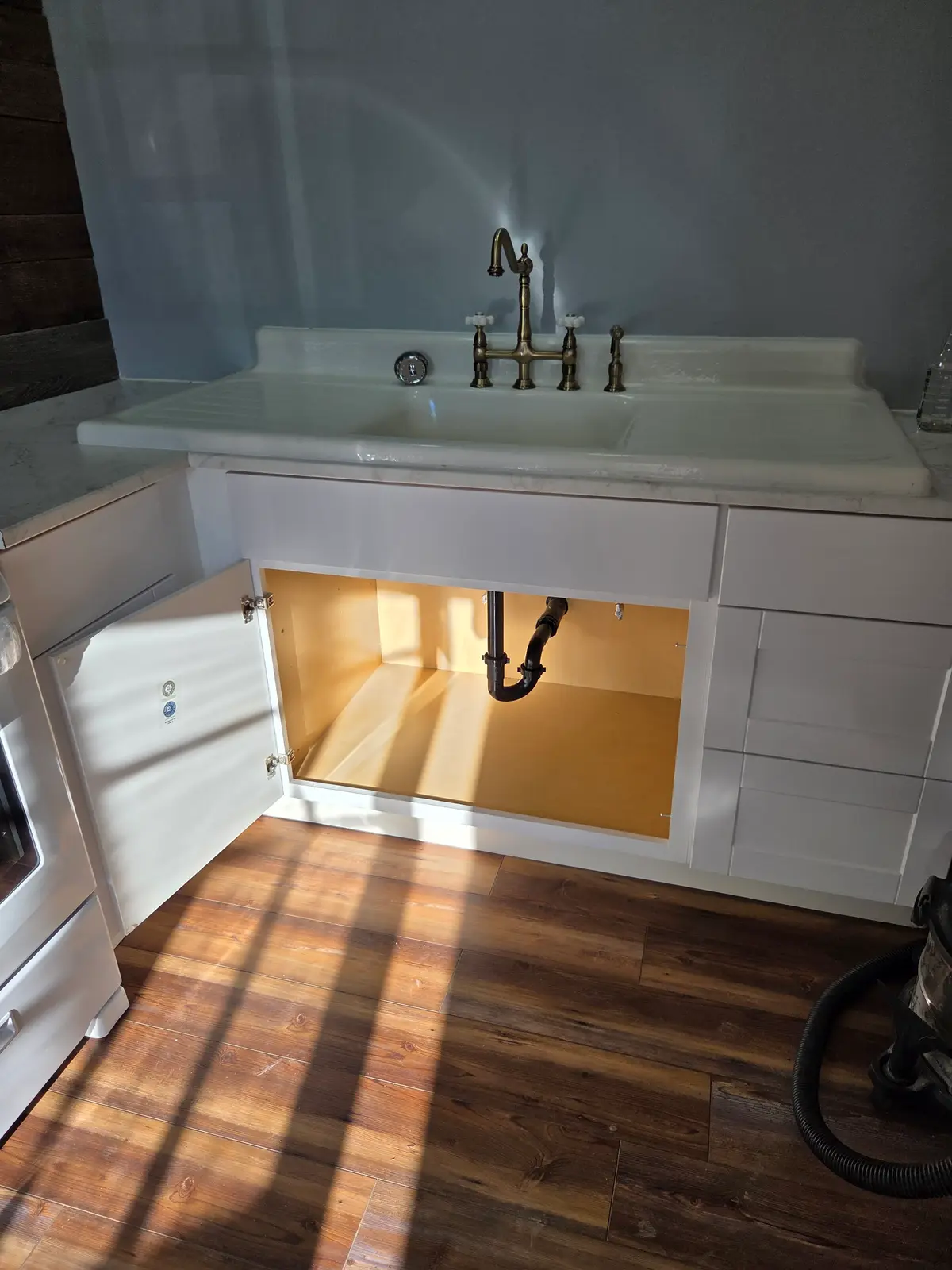 New kitchen faucet and under-sink plumbing installed by Revolution Plumbing